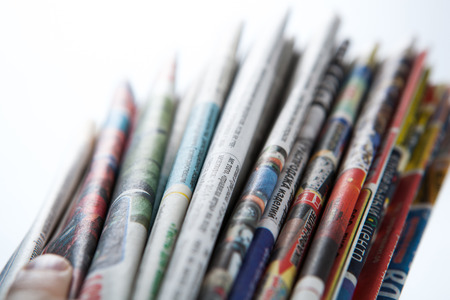 stack of newspapers close-up on whiteの写真素材