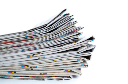 stack of newspapers close-up on whiteの写真素材