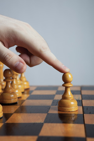 hand of man making a move chess figureの写真素材