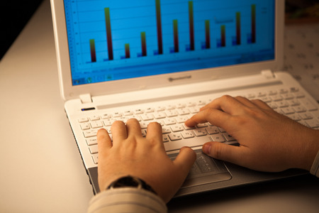 human hands on the notebook keyboard close-upの写真素材