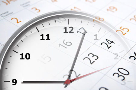 sheet of a calendar with the number of days and clock close-upの写真素材