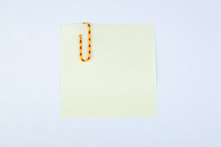 sheet of pad yellow paper witn paper clip close-up