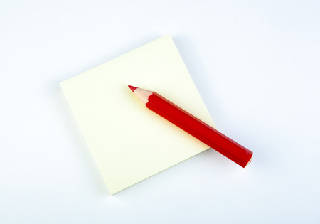 stack sheet of pad yellow paper with red pencil close-upの写真素材