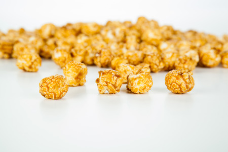 lots of popcorn balls with sugar on a white backgroundの写真素材