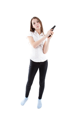 young girl holding a pistol on a white backgroundの写真素材