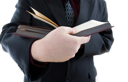 man holding an open book close-up on a white