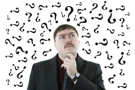 portrait of a man thinking question with question symbols on a white backgroundの写真素材