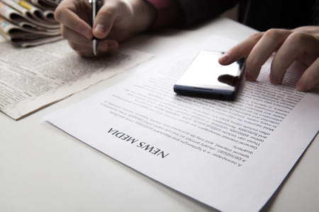 man working on a smartphone in office close-upの写真素材