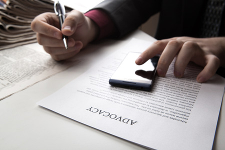 man working on a smartphone in office close-upの写真素材