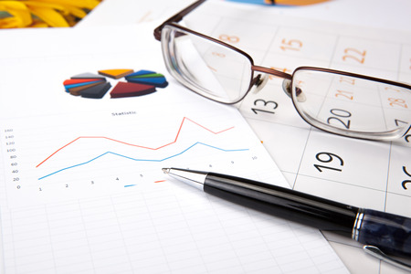 open diary with large pen on whiteの写真素材