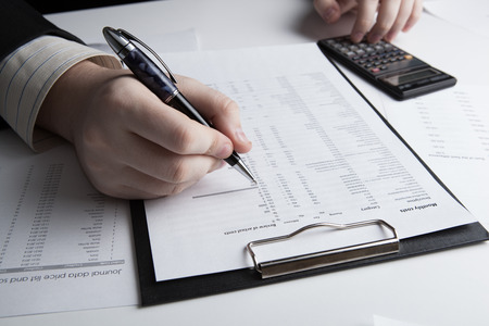 man is looking for information in the in the budget figures close-upの写真素材