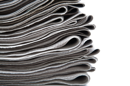 stack of newspapers on a white background closeupの写真素材