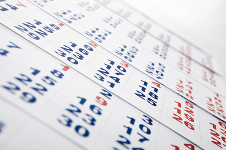 sheets of wall calendar with the number of days close-upの写真素材