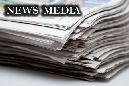 stack of newspapers on a white background closeupの写真素材