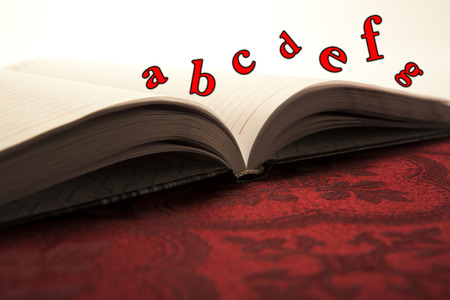 open business diary on red textile close-upの写真素材