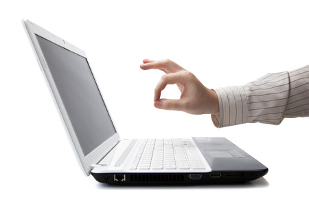 hand man lies on the laptop keyboard on a whiteの写真素材