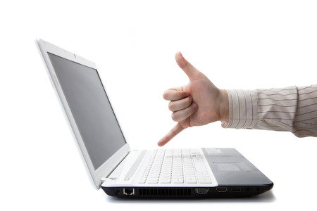 hand man lies on the laptop keyboard on a whiteの写真素材