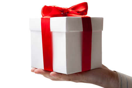 white gift box with red ribbon in hand on white backgroundの写真素材