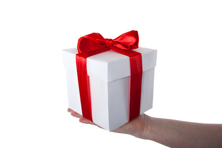 white gift box with red ribbon in hand on white backgroundの写真素材