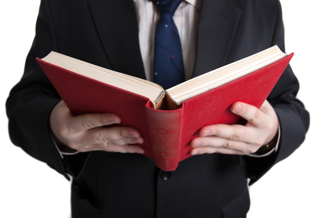 man holding an open red book closeup on a whiteの写真素材