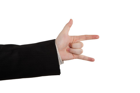 man's hand indicates horns on a whiteの写真素材