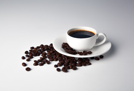 cup of black coffee and roasted coffe beans close-upの写真素材