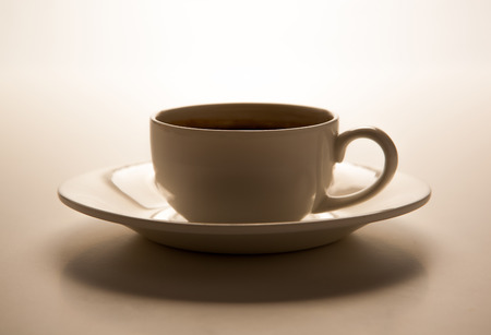 glass cup and saucer closeup on greyの写真素材