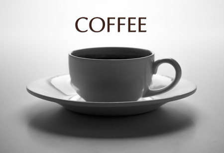 glass cup and saucer closeup with title coffee on greyの写真素材