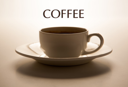 glass cup and saucer closeup with title coffee on greyの写真素材