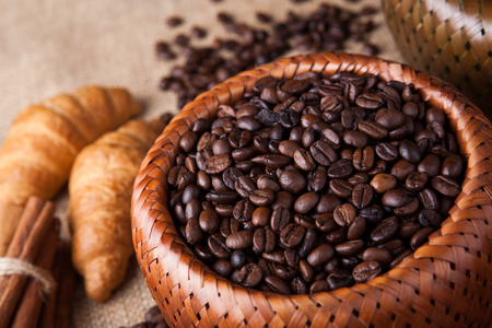 roasted coffee beans in a bamboo basket still lifeの写真素材