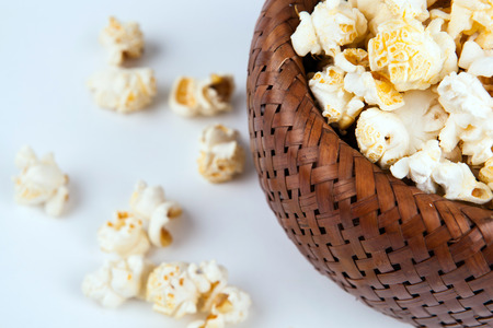 lot of salt popcorn into a bamboo bowl close upの写真素材