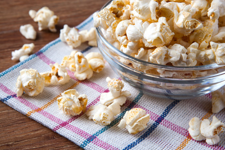 lot of salt popcorn into a bowl close upの写真素材
