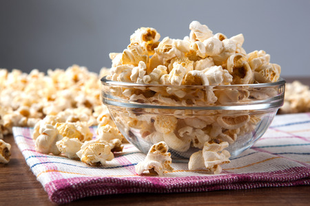 lot of salt popcorn into a bowl close upの写真素材