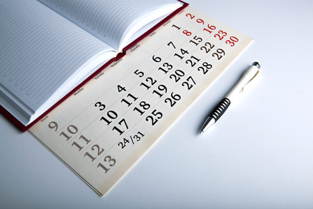 calendar days with numbers and pen close upの写真素材