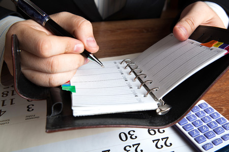 man running with diaries with pen close upの写真素材