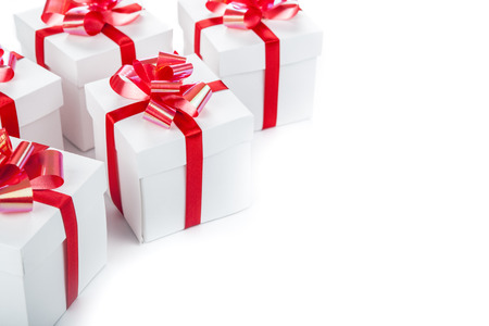 White gift boxes with red ribbons and bows on grayの写真素材
