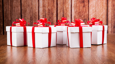 white gift boxes on a wood backgroundの写真素材