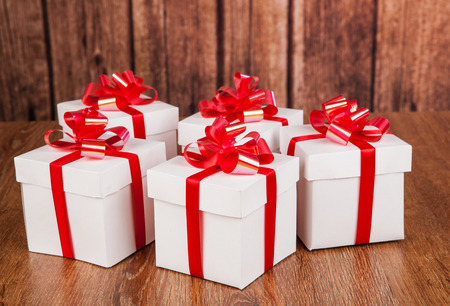 white gift boxes on a wood backgroundの写真素材