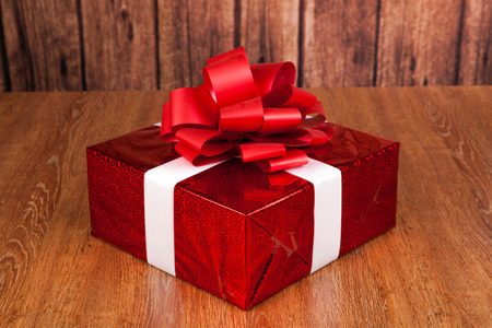 one large red gift box on a wood backgroundの写真素材