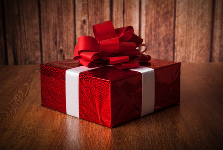 one large red gift box on a wood backgroundの写真素材
