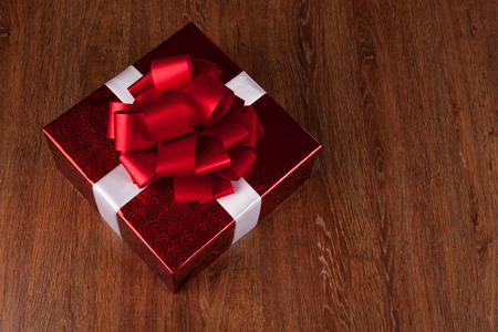 one large red gift box top view on a wood backgroundの写真素材