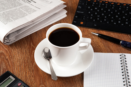 business still life with cup of black coffee on desktopの写真素材