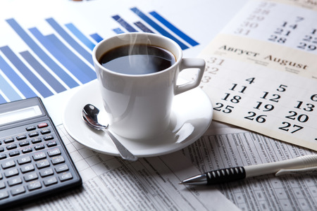 business still life and cup of coffee with newspapersの写真素材