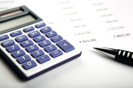 work on the calculator and papers close upの写真素材