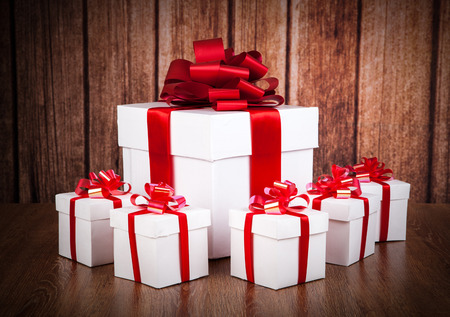 one large white gift box and white gift boxes on a wood backgroundの写真素材