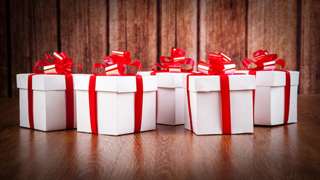 white gift boxes on a wood backgroundの写真素材