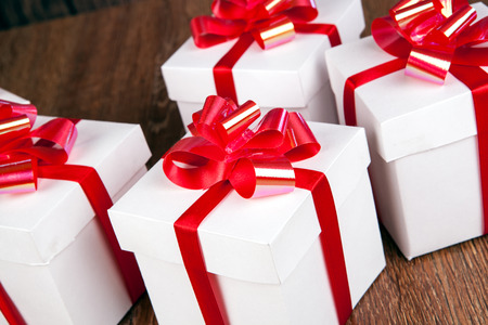 white gift boxes on a wood backgroundの写真素材