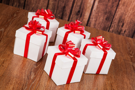 white gift boxes on a wood backgroundの写真素材