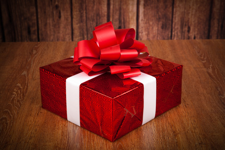 one large red gift box on a wood backgroundの写真素材