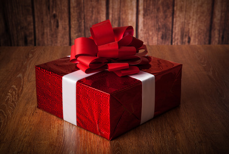 one large red gift box on a wood backgroundの写真素材